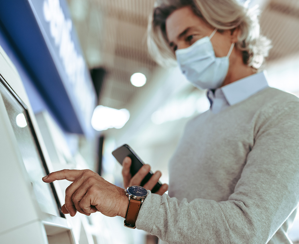 Man in a mask using a terminal